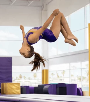 Gymnast performing a back flip during tumbling training