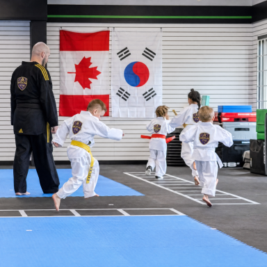 hf_20260616_055534_f7a8a5d3-75e1-43e3-85e7-31eecf8fc974 Taekwondo class lined up in front of the Canadian and Korean flags at The RAZ