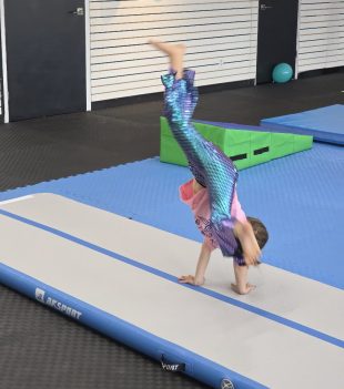 Child doing a cartwheel on the inflatable air track at The RAZ in Rockland