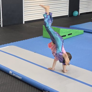 Child Cartwheel on Gymnastics Air Track in Rockland Child doing a cartwheel on the inflatable air track at The RAZ in Rockland