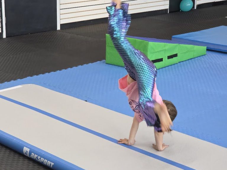 Child doing a cartwheel on the inflatable air track at The RAZ in Rockland